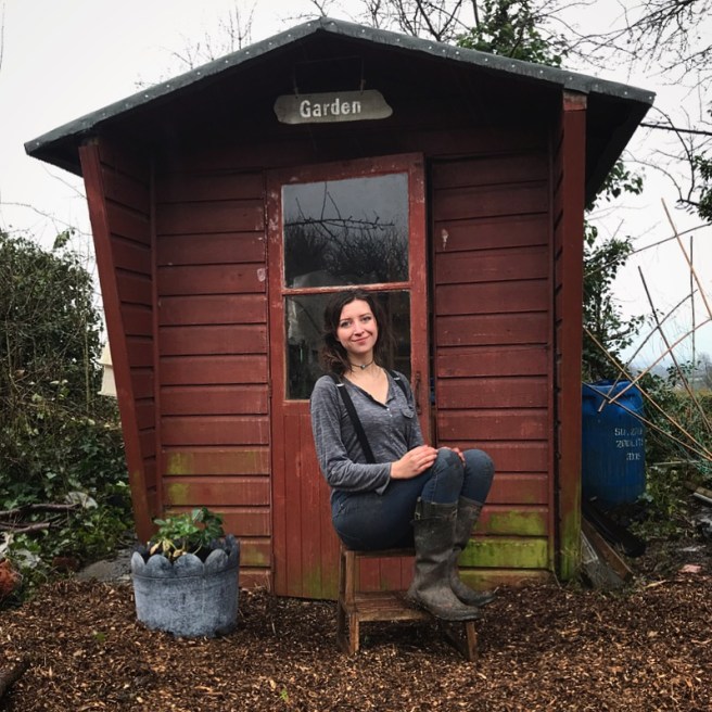 Allotment gardener Katrina, sat outside her shed.